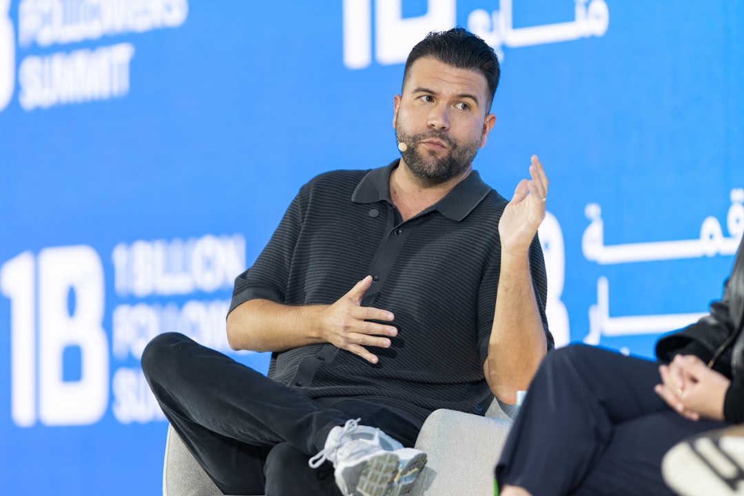 Man speaking on a panel with a blue background