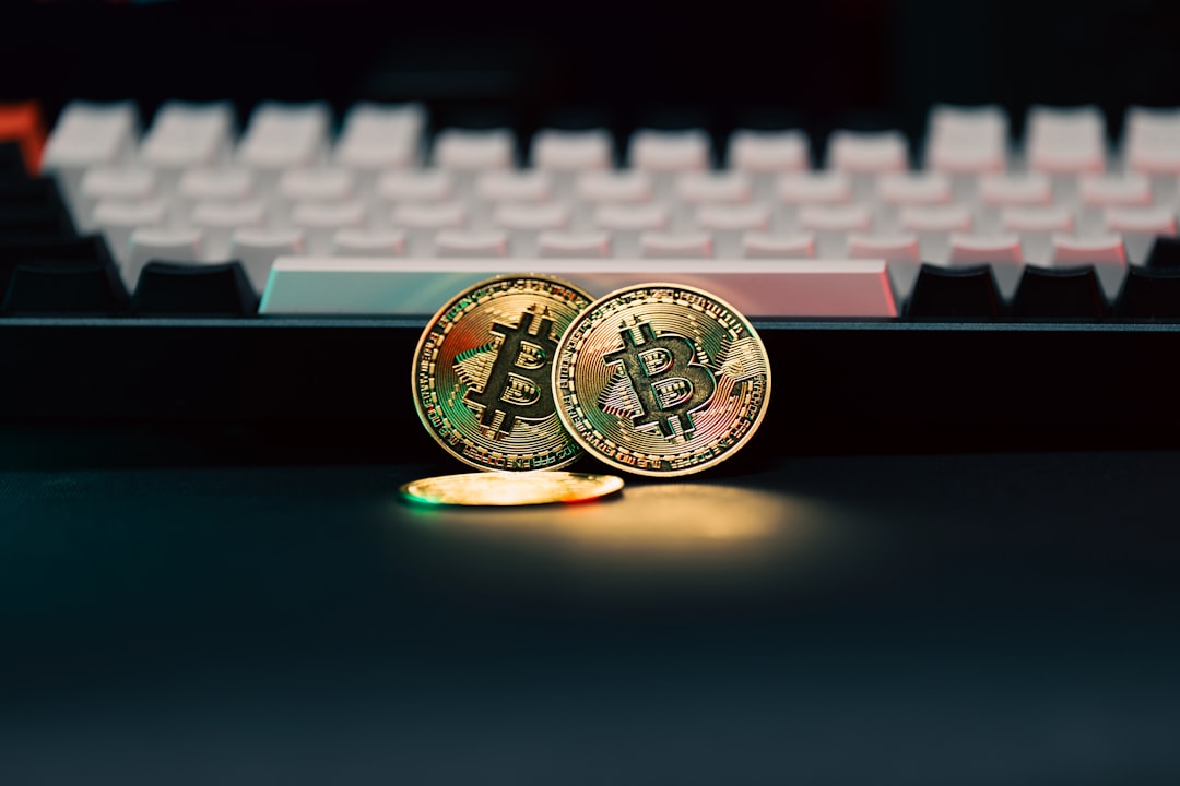 Two bitcoins sitting next to a computer keyboard