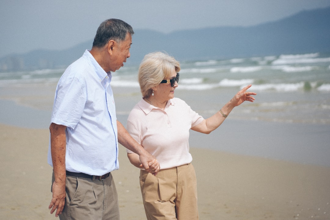 Elderly couple walking on a sandy beach