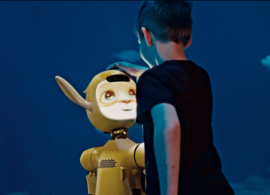 A young boy gently pats a yellow robot's head.